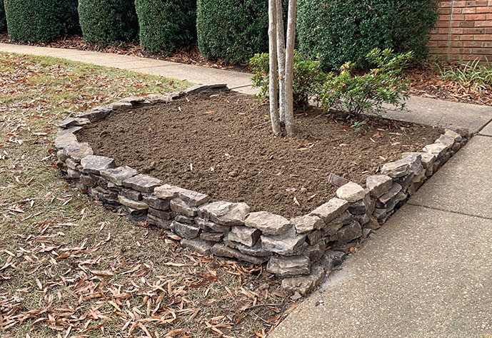 Beautiful stacked stone flower bed designed and installed by Edmonds Environmental